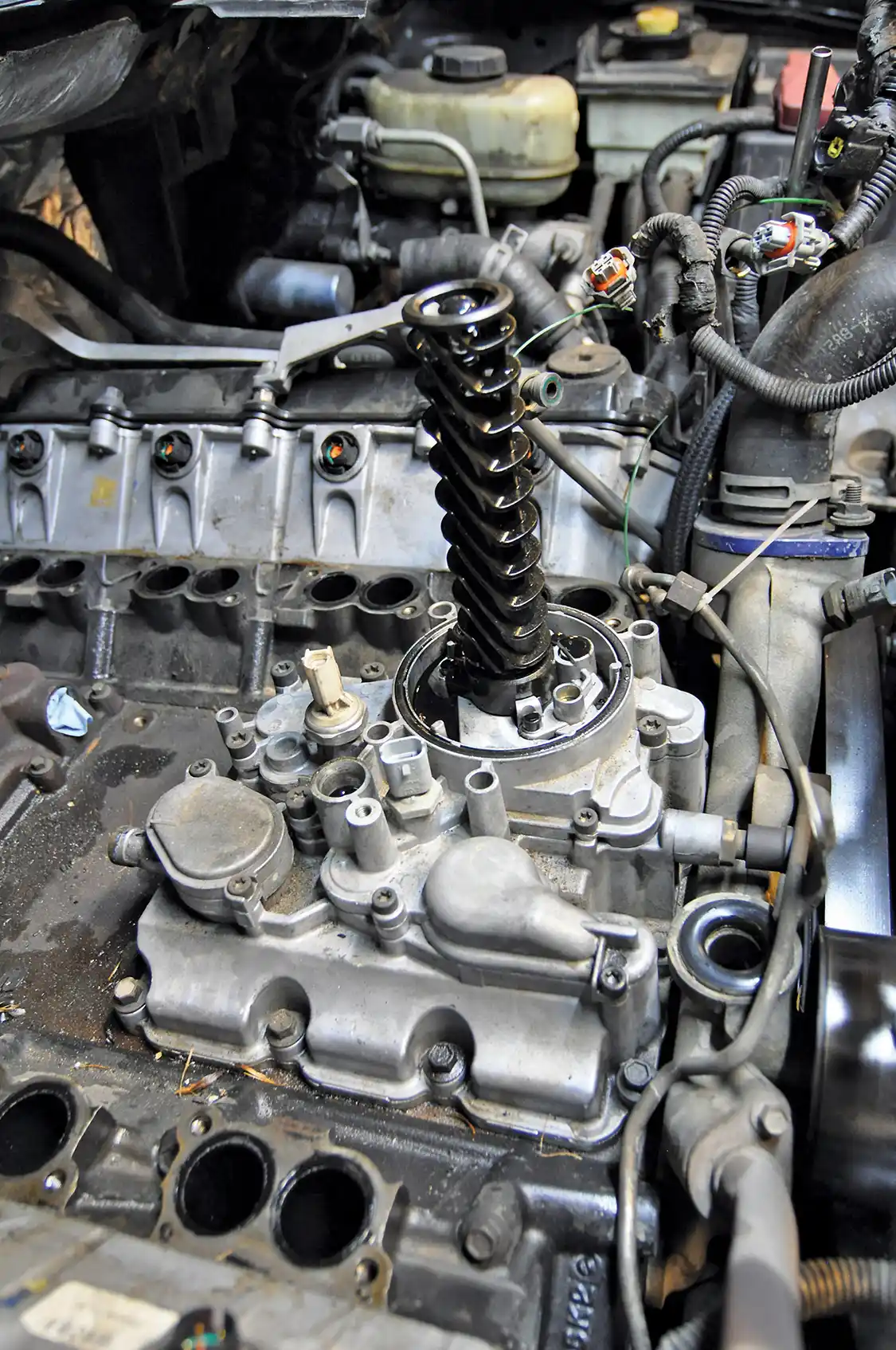 6. This is the factory oil cooler assembly. Most of it will be replaced with new Bullet Proof Diesel parts. The black tube is what the oil filter surrounds.