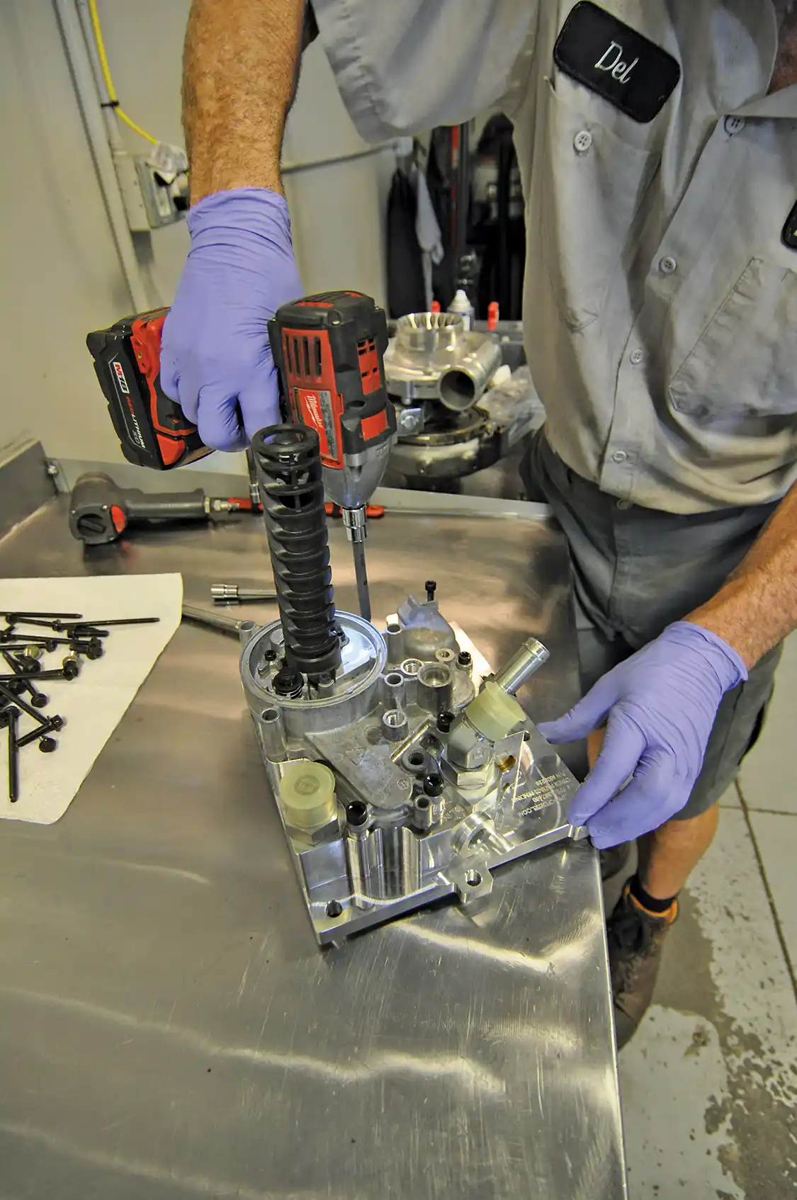 10. Next Wamsley readied the new Bullet Proof Diesel oil cooler relocation manifold for installation by bolting the factory oil filter assembly to it using some of the factory bolts and a few replacement ones provided by Bullet Proof. He also installed all new gaskets and swapped any sensors over.