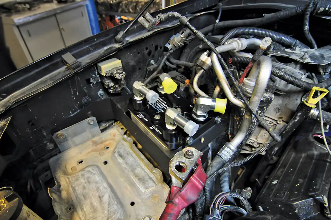 23. The assembly then bolts onto the previously installed bracket using four bolts, two per side. All are easily accessible for future service as that’s the point of this kit: to make servicing the oil cooler eons easier than before.