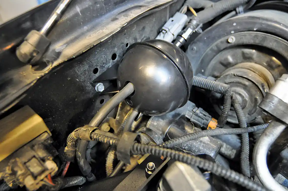 24. Previously, the factory vacuum canister was removed to make room for the oil cooler’s new home. It is replaced with this vacuum canister supplied by Bullet Proof Diesel. While it’s substantially smaller, it did not affect any vacuum powered accessories at all.