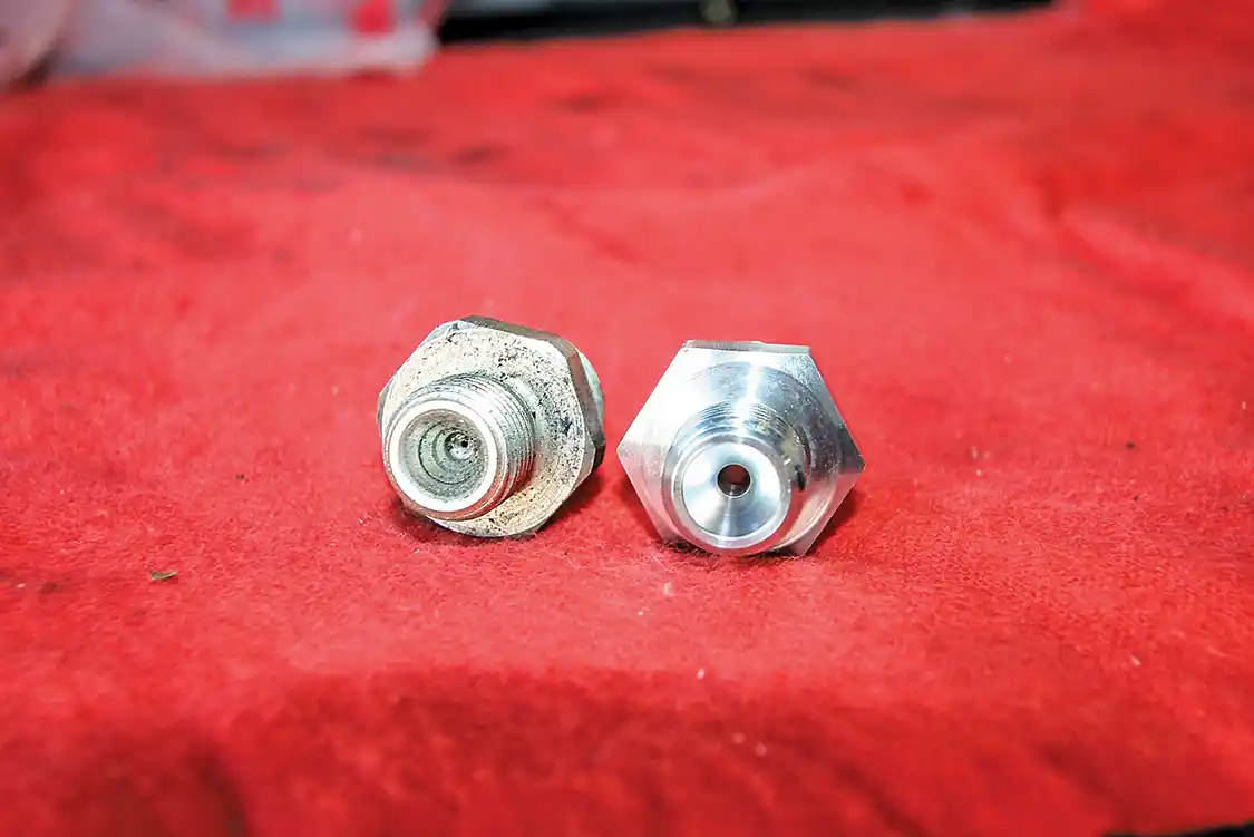 8. We told you the PPE unit had a visibly larger fuel feed hole: Look at the tiny stock unit on the left compared to the PPE unit on the right.