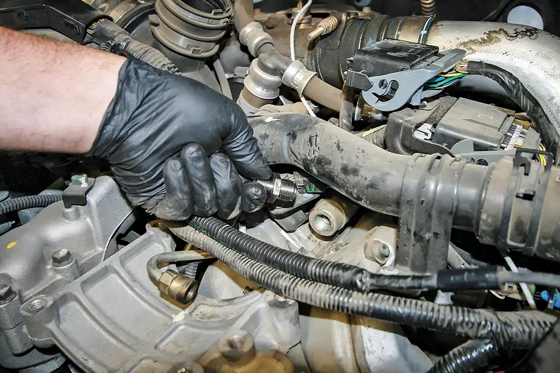 10. Buried underneath some wires and tubes is the passenger’s side fuel line fitting. Simply remove the OEM one and install the PPE unit.