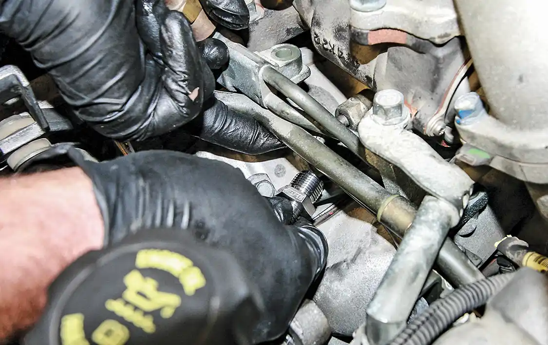 13. The driver’s side fuel rail fitting is located underneath plenty of components so be patient when gaining access to it. Remove and replace the unit just as we displayed for the other side.