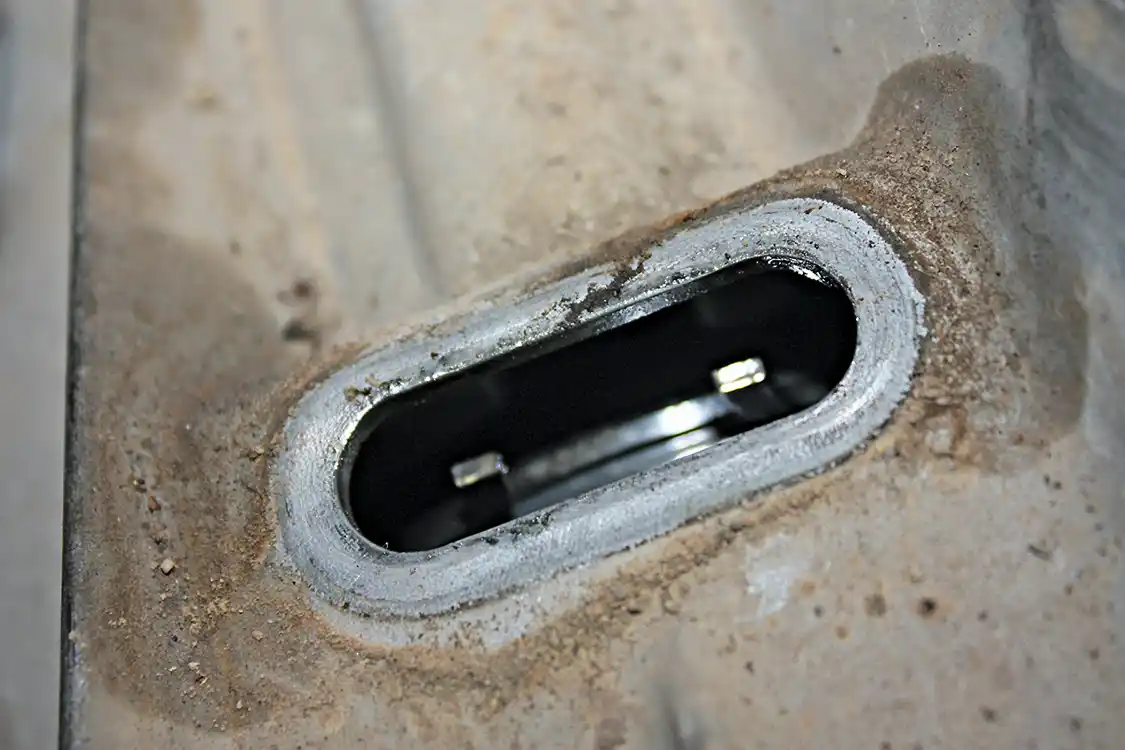 11. This is the snap ring that is found inside that rubber grommet; you’ll need a good pair of external snap rings to open it up enough that the tail shaft can be slid forward enough to come loose of the snap ring.