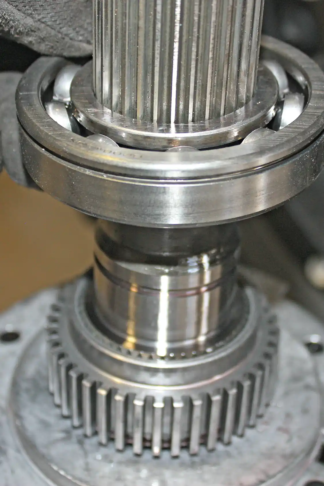 19. Then the large bearing could be removed in the same fashion; it is a rather tight fit on the tail shaft, but with some finesse and wiggling it should slide right off.