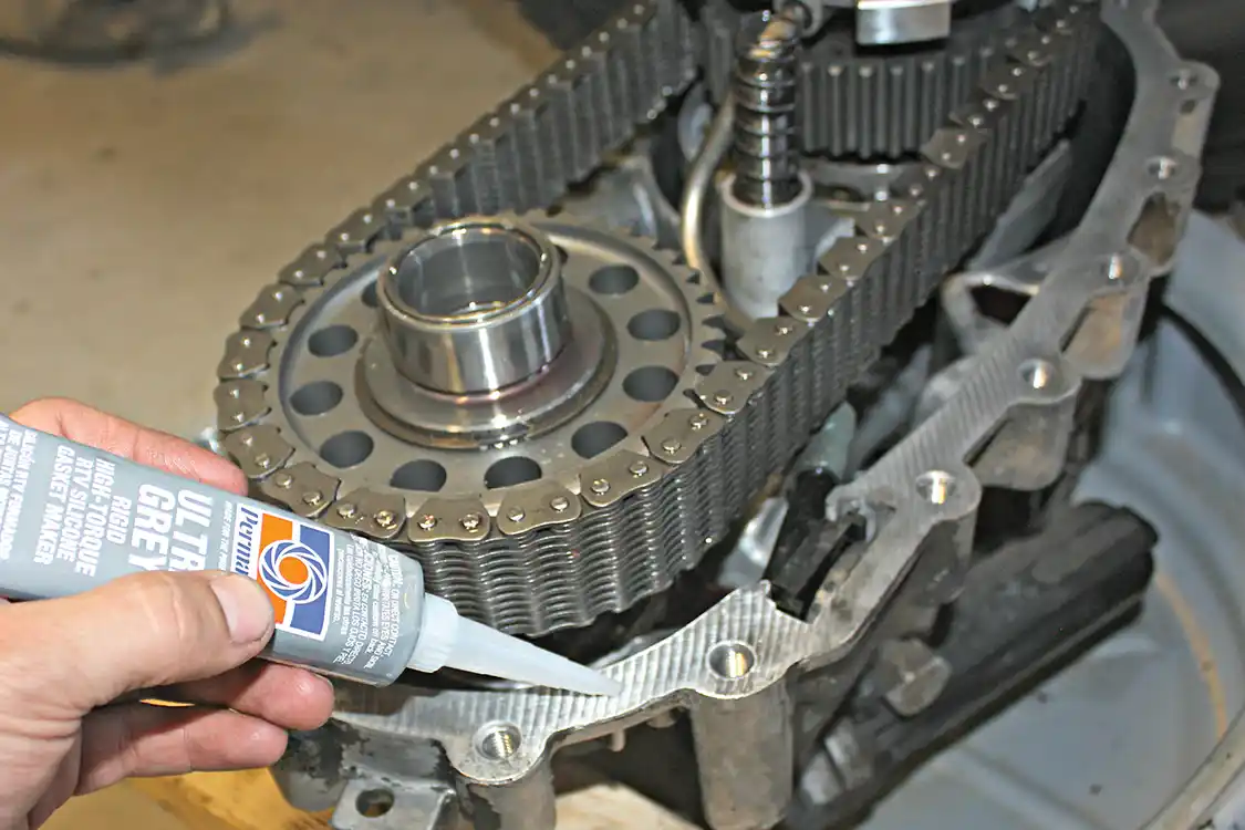 24. Once the pump, gear, bearing and snap ring are reinstalled, the pick-up tube can be inserted back into the pump and the rear case can be reinstalled. You’ll need to be sure to grab a small tube of gasket maker at your local auto parts shop to seal the cases. Make sure both surfaces are clean of the old sealant before applying a solid bead of the new all the way around.