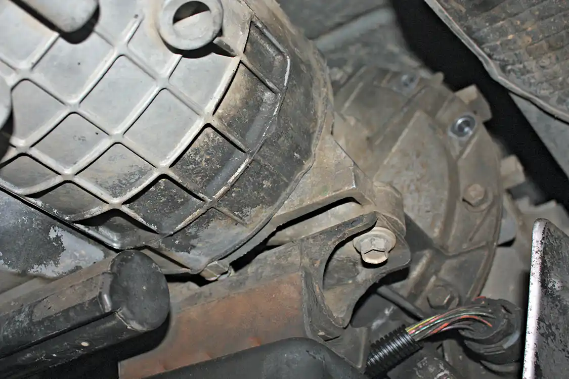 5. The cross member attaches to the transmission with just two bolts through the mid-mount. Our tech opted to remove the bolts that attached the cross member to the mount, then removed the cross member from the truck. After it was out of the way, accessing the mounts bolts that attach it to the transmission itself was much easier.