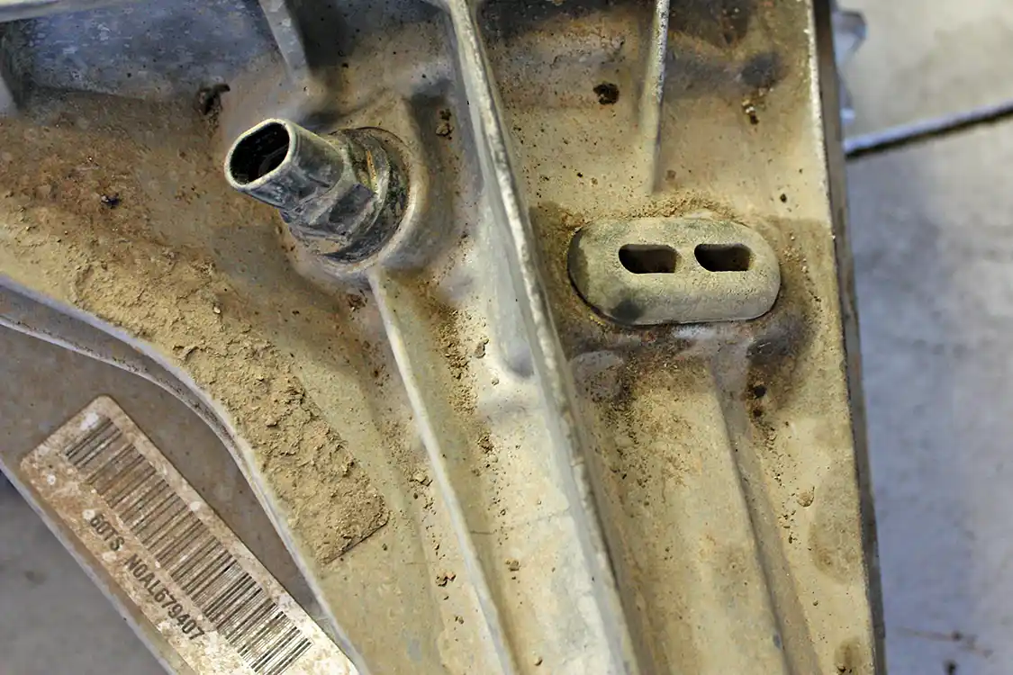 9. Disassembling the transfer case further will require an internal snap ring to be opened and slid off the main tail shaft. To access this snap ring, the rubber grommet needs to be removed, along with the tail shaft speed sensor.