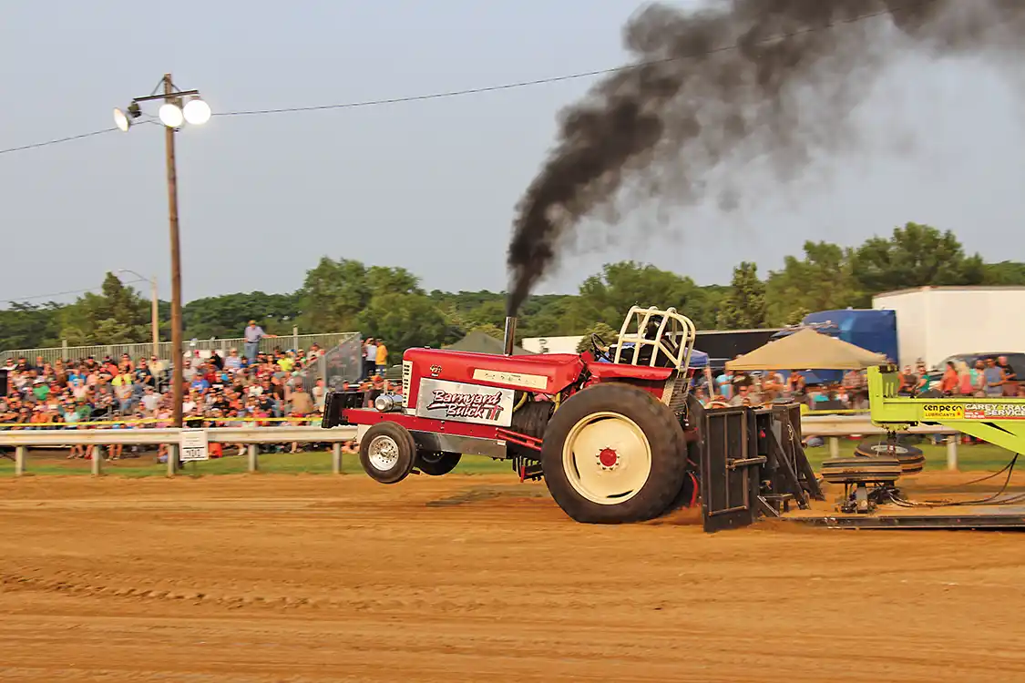 A slew of hot-running tractors showed up for the 9,500-pound 466 class sanctioned by the Heartland Tractor Pullers Association. Here, Tim Vorwald lays down a textbook pass with his Farmall 450. He would finish in Third Place with a distance of 301.9 feet.