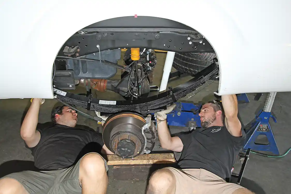 11. The rear springs are heavy, and it is best to have help when removing the OEM pack, especially when reinstalling the new and thicker pack in the Carli kit.