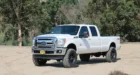 Seen here is a stock F-250 (top). Here's the same truck with a Carli Suspension Dominator 3.0 kit (bottom).