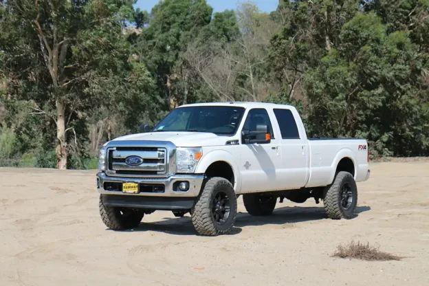 Seen here is a stock F-250 (top). Here's the same truck with a Carli Suspension Dominator 3.0 kit (bottom).