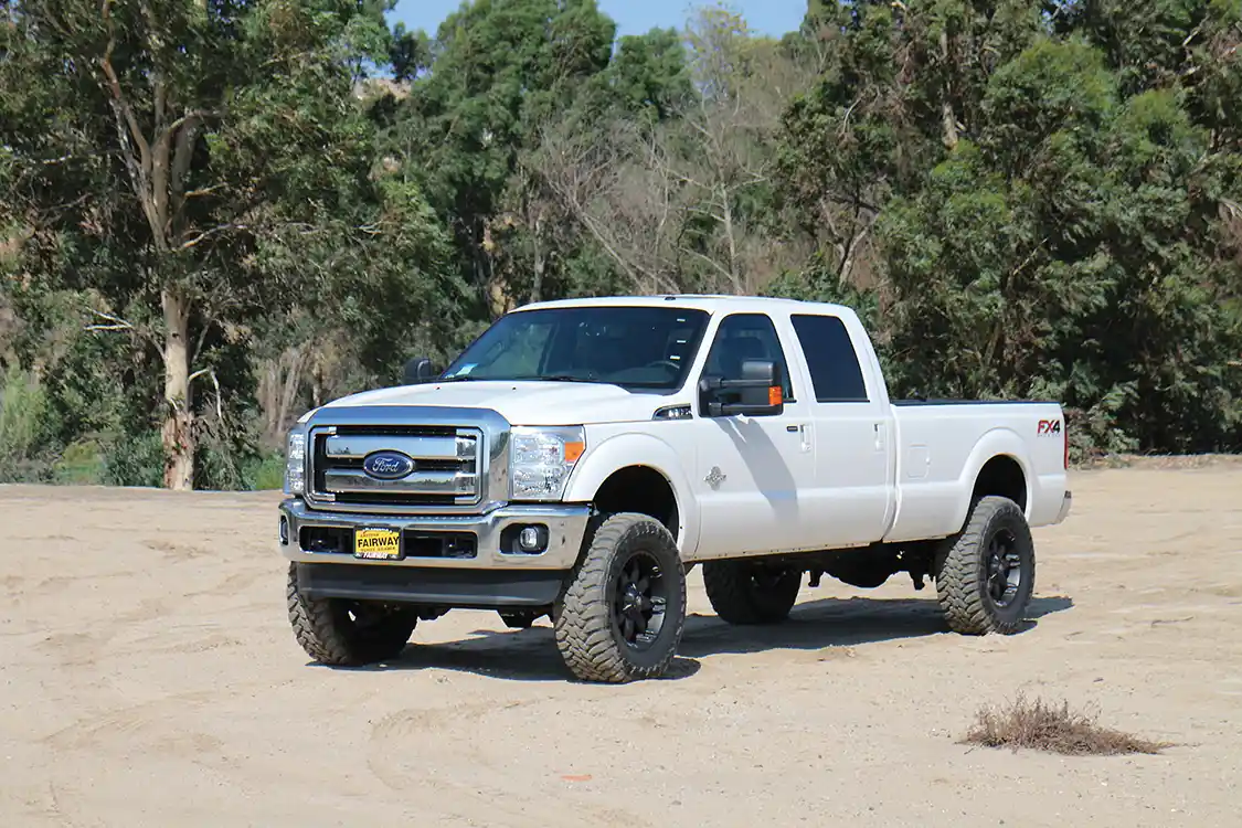 Seen here is a stock F-250 (top). Here's the same truck with a <a href="https://carlisuspension.com/">Carli Suspension</a> Dominator 3.0 kit (bottom).