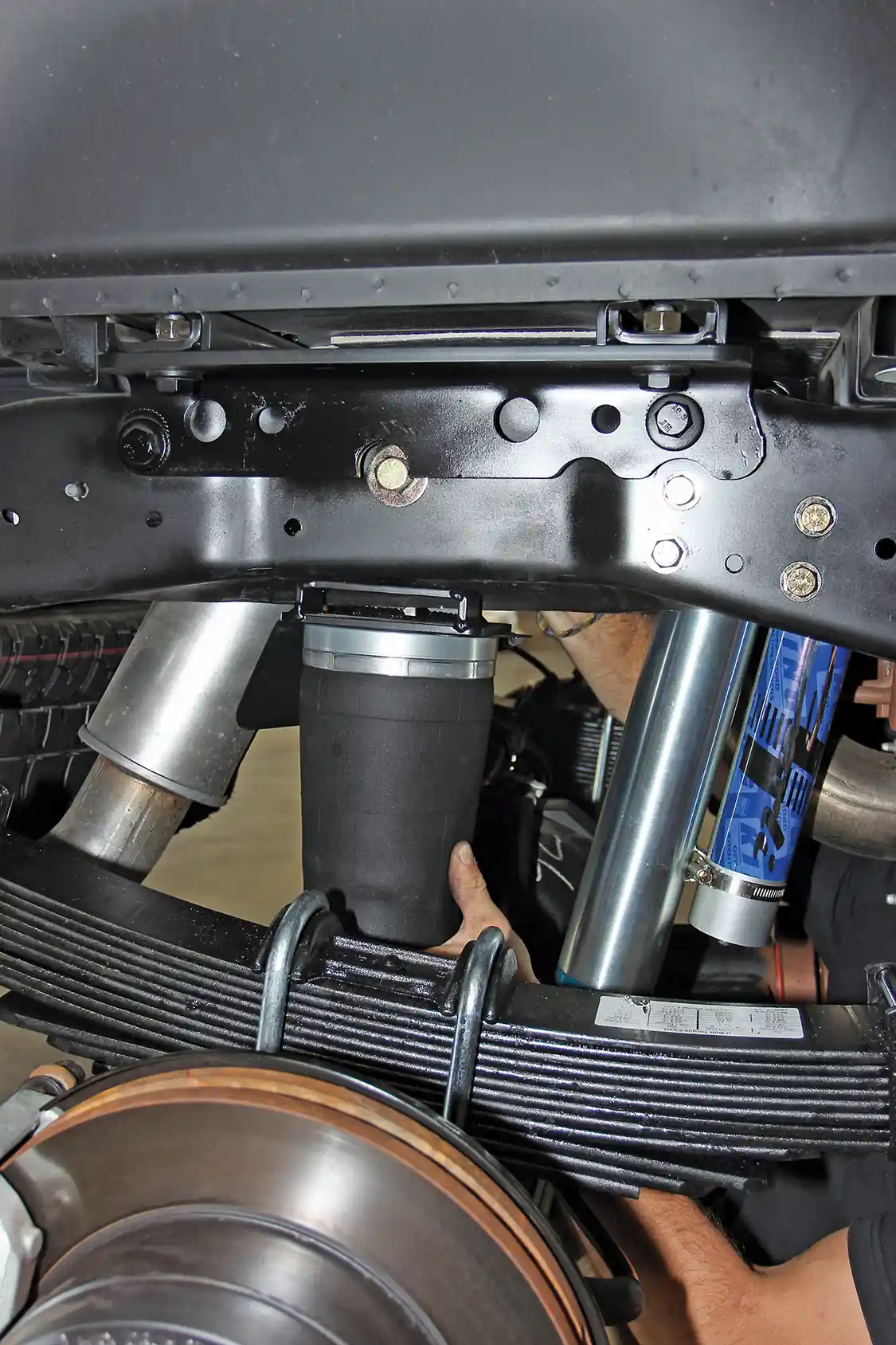 15. With the new the new remote reservoir shock installed, the rear air bags can be installed. These air bags add the extra carry capacity needed to level the truck at max OEM load. This is an upgrade to the basic suspension kit, but well worth it on any truck that often carries heavy or tows with big trailers.
