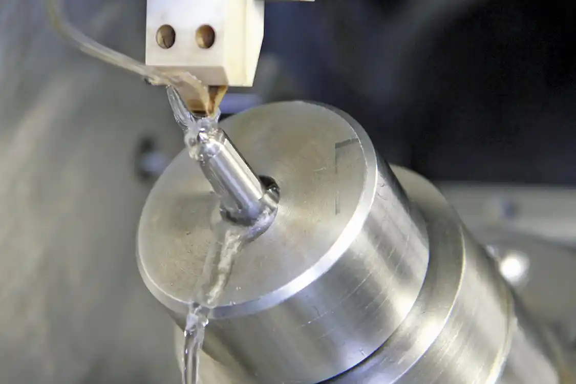 2. While the EDM operation is underway, dielectric liquid flows across the nozzle tip making the “spark” or actual removal of material from the nozzle barely visible.