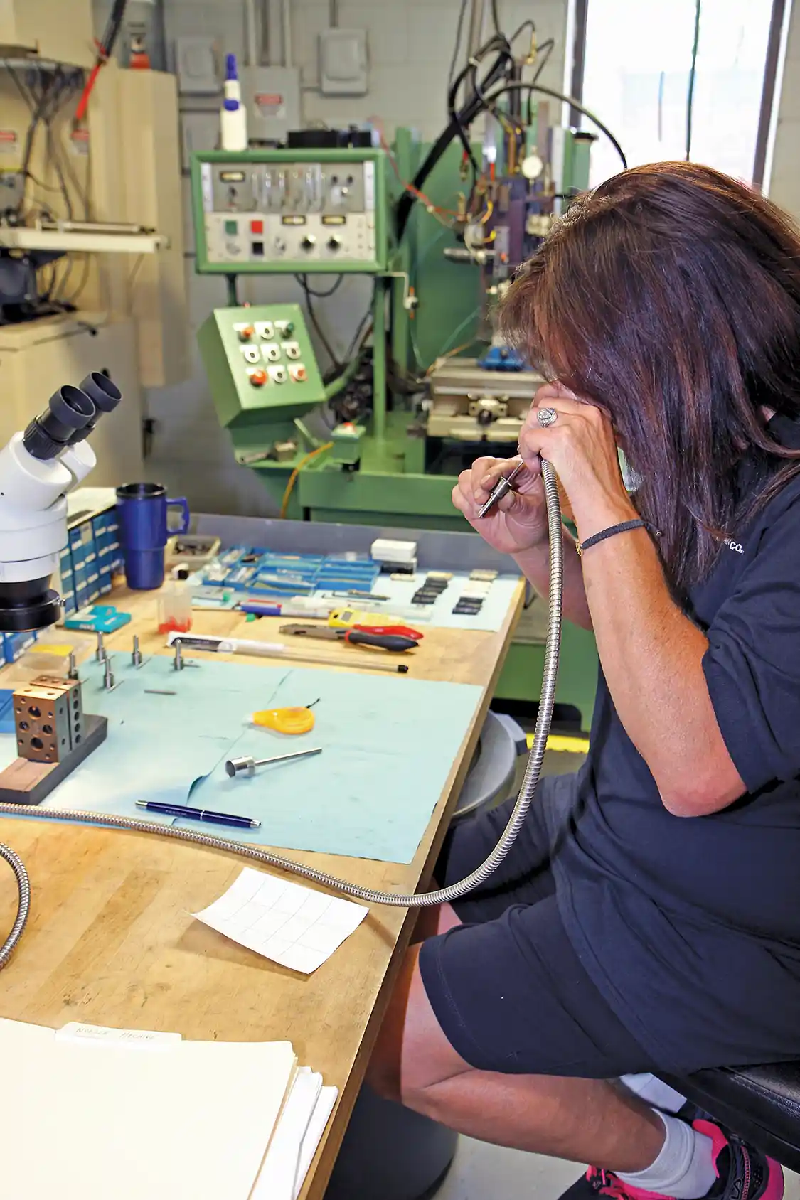 4. Ruth McLachlan inspects the inside of a nozzle with a borescope after the EDM machining is complete to make sure that the holes were properly cut.