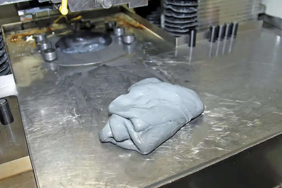 11. The abrasive media looks and feels like “Silly Putty” that you probably played with as a kid. When it is forced through the nozzle abrasives within, the media removes material from the internal walls of the nozzle as it flows past.