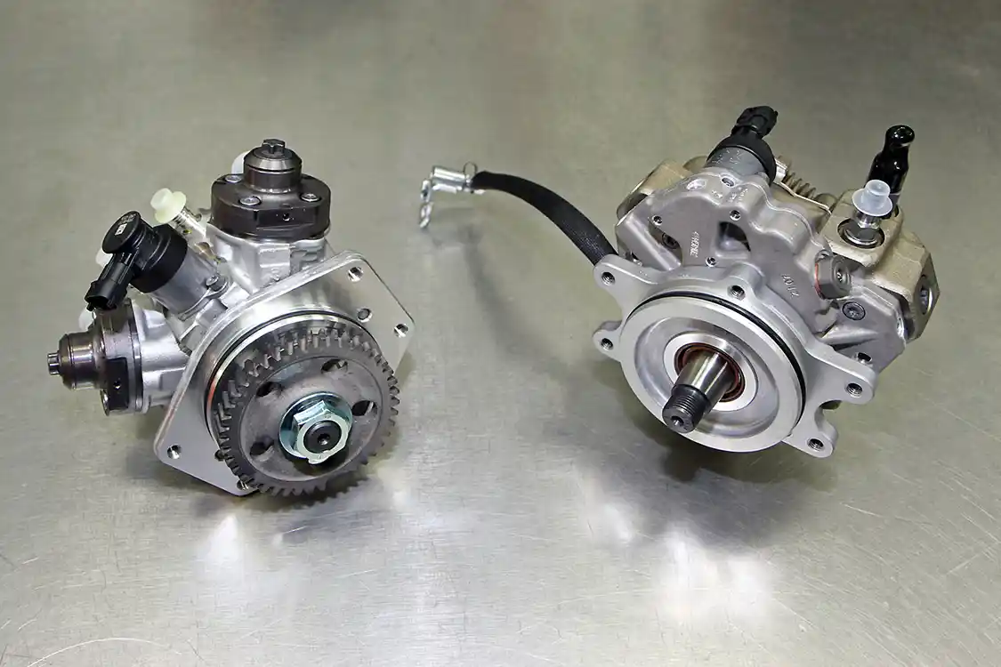 18. A stock CP4 is shown on the left with the S&amp;S replacement CP3 unit shown on the right. The CP4 to CP3 upgrade kit for the Duramax engine will even work with the ninth injector for emissions compliance, while replacing the troublesome CP4 with the more reliable CP3.