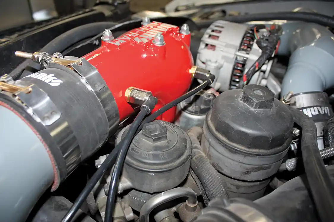 19. The dual stage nozzles for this system are drilled and tapped into the backside of the High Ram intake elbow. The primary stage is drilled right at the elbow inlet, while the power shot is tapped directly into the main bowl of the elbow, maximizing atomization and water/methanol distribution into the airstream to the intake manifold and cylinder heads.