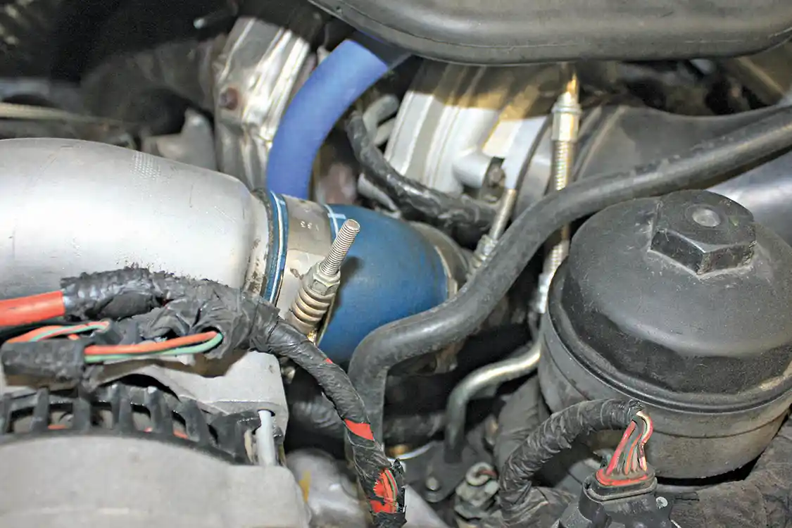 6. The passenger side (hot side) intercooler pipe connects directly to the turbocharger with this small 45-degree boot. This boot is prone to cracking and leaking, at which we were surprised to find hadn’t yet happened to this 135,000 mile truck.