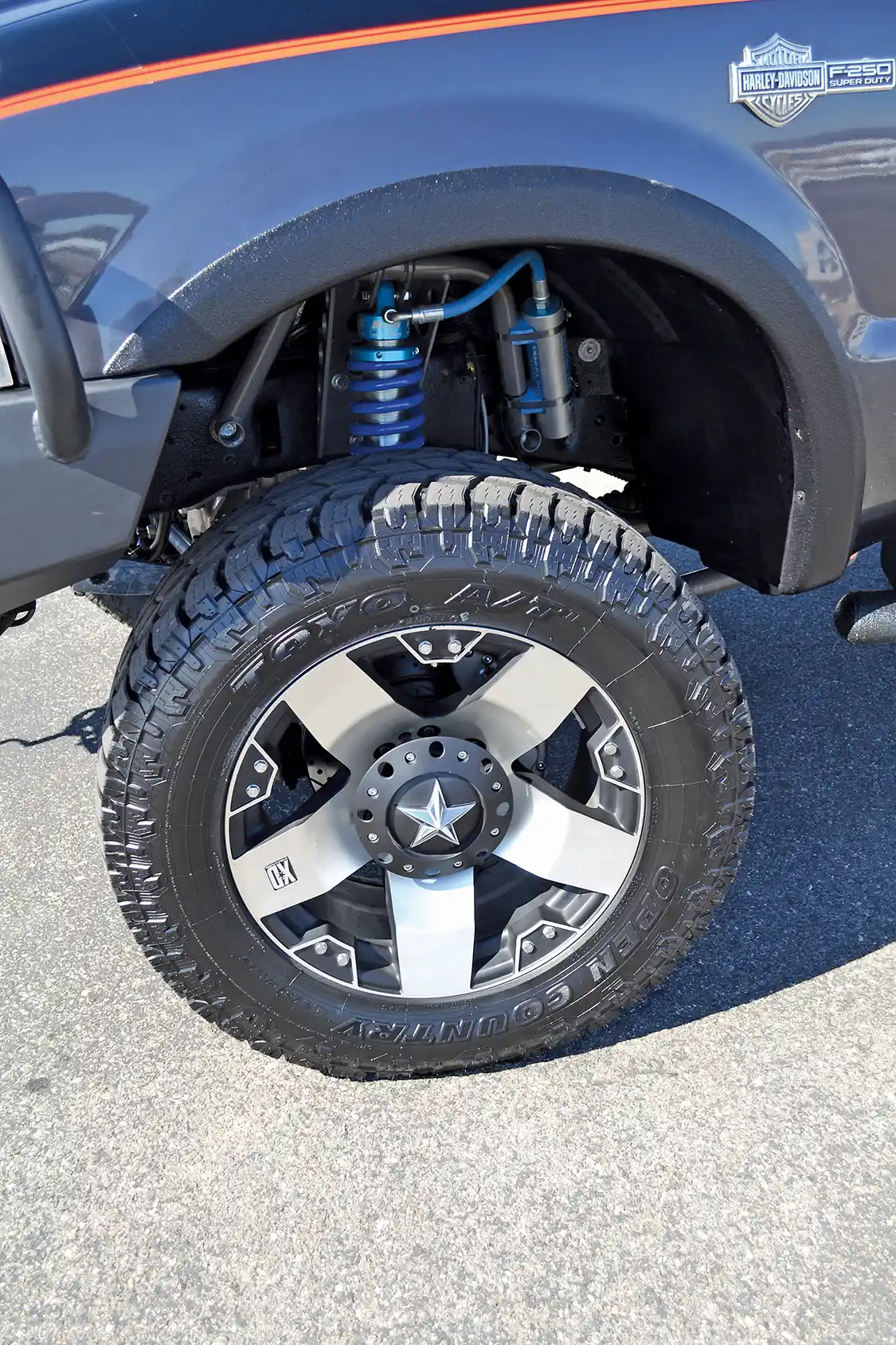 The oversized 20-inch XD Series Rockstar wheels match the paint and stance of the Harley truck perfectly, while 35x12.50R20 <a href="https://www.toyotires.com/">Toyo</a> Open Country A/Ts provide a smooth ride. The custom remote-reservoir shocks are from <a href="https://www.kingshocks.com/">King</a> and part of a 4-link 4-inch lift conversion kit from <a href="https://full-traction.com/index.php">Full Traction</a>.