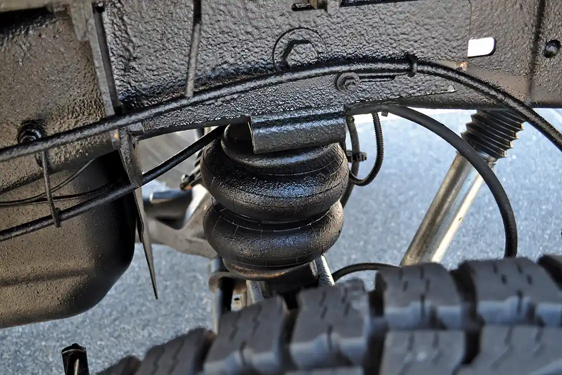 The rear suspension has been extensively upgraded to handle the massive loads that Brig often has in tow. A set of progressive rate springs from <a href="https://deaverspring.com/">Deaver</a> lift the Harley truck slightly to match the front, while <a href="https://www.bilstein.com/us/en/">Bilstein</a> shocks and <a href="https://www.firestoneip.com/">Firestone</a> airbags help with support under load.
