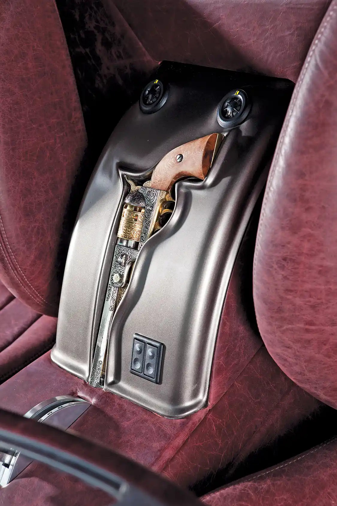 The custom center console, seen here, is fitted with an antique 1845 Colt revolver.