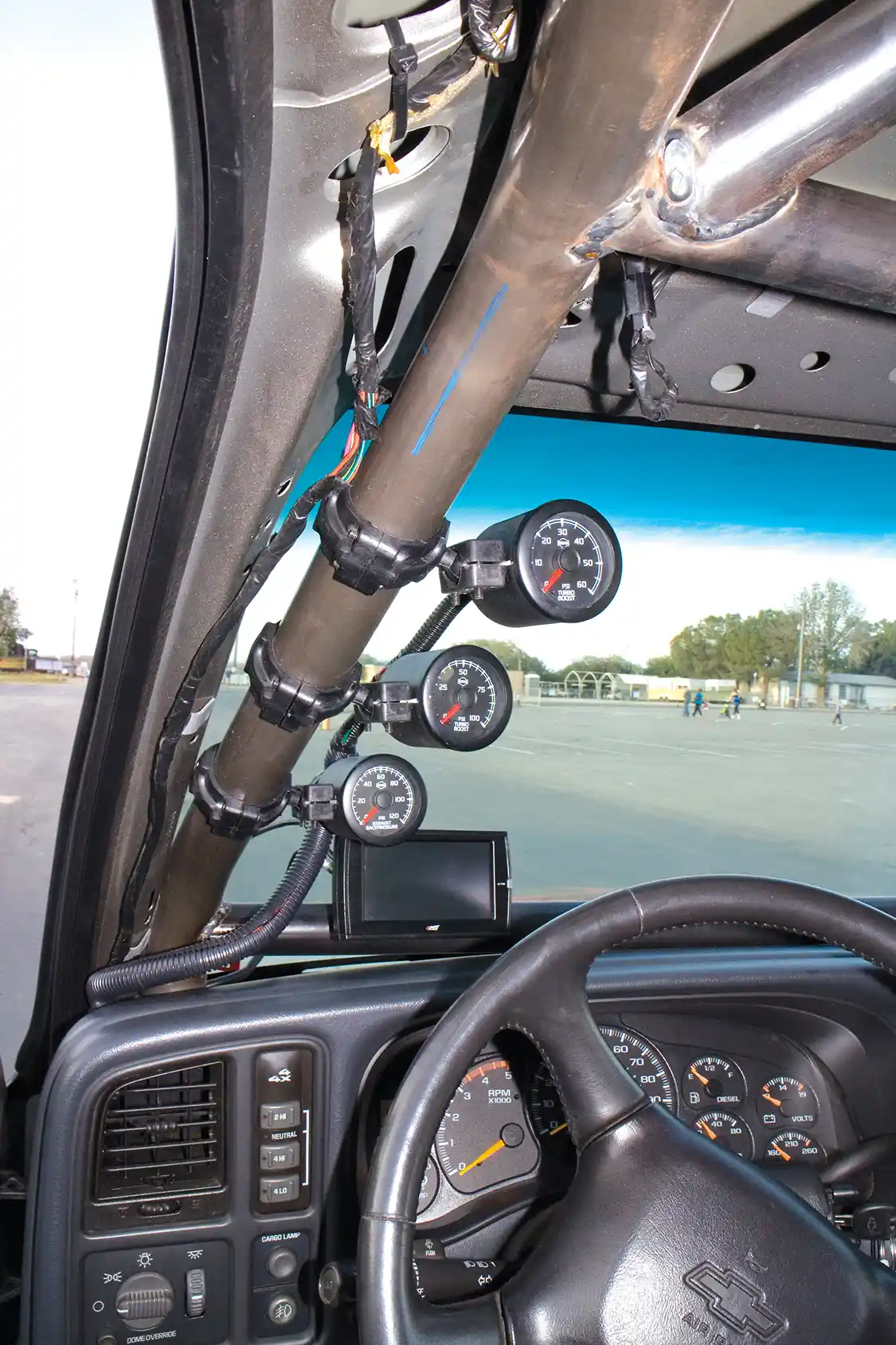 An A-pillar gauge mount houses <a href="https://www.isspro.com/">ISSPRO</a> gauges. These are, top to bottom, Turbo Boost, Turbo Boost and Exhaust backpressure. The twin turbos each have their own gauge. Also you may notice the <a href="https://edgeproducts.com/">Edge</a> CTS on the roll cage cross bar.