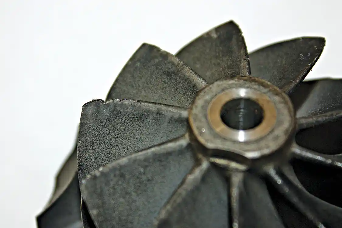 3. The original 60mm 10-blade compressor wheel that comes in the stock LB7 turbocharger is sufficient in a stock application and will support up to 530 rwhp with the right supporting mods, but its design really limits flow as engine RPMs increase. This creates a very ‘peaky’ power curve with power peaking around 2,700 rpm, at which point, power will start dropping drastically. This particular compressor wheel shows signs of poor air filtration and dusting that has damaged the front edges of the blades, which also hurts performance.