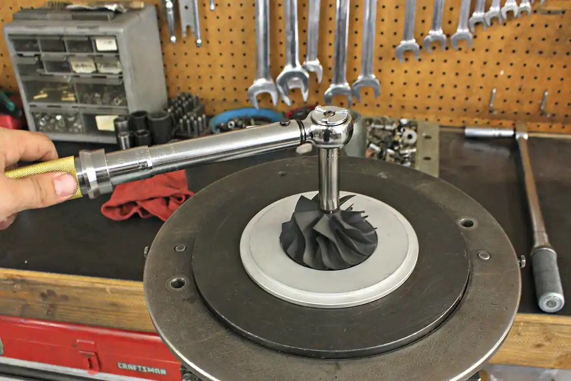 5. After some machining is completed on the compressor side back plate and the rotating assembly has been balanced, the center section can be assembled with all new internals that include new bearings, piston rings, snap rings and seals. The shaft and wheel are then torqued to spec.