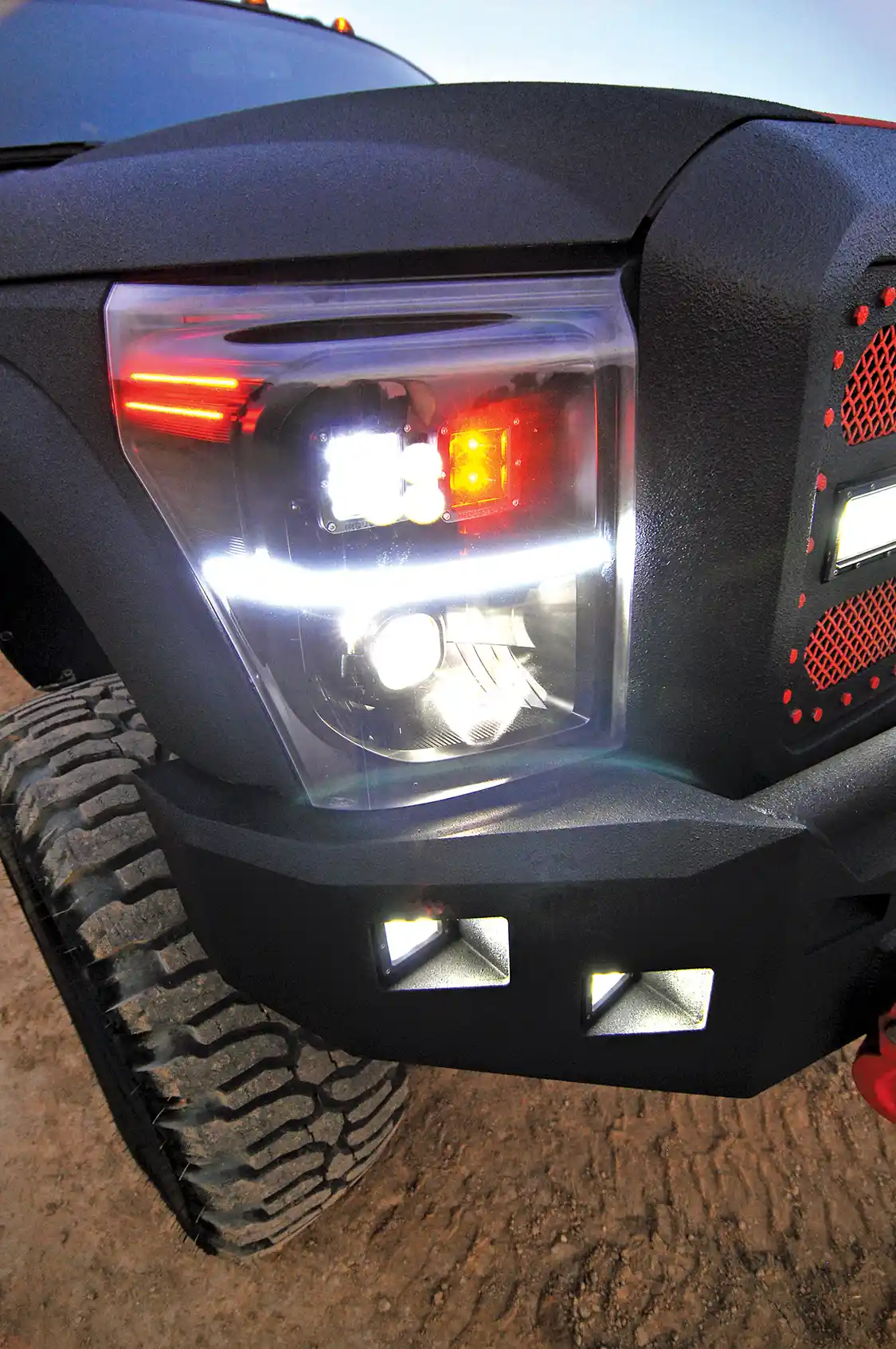 <a href="https://eco-tint.com/">EcoTint</a> custom built a set of headlights for Keaton’s truck. They’re painted to match and feature Diesel Power Gear LEDs in place of the stock incandescent lights.