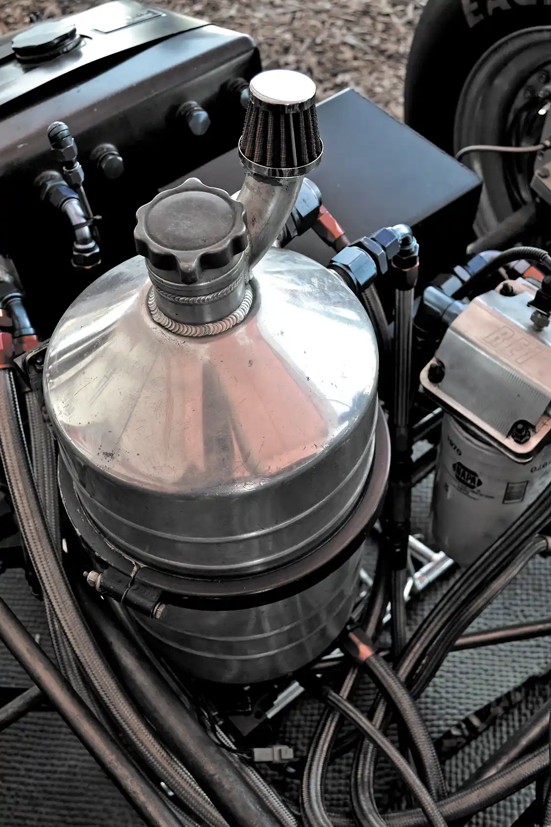 John's altered has a very extensive breather system to help reduce crankcase pressure to nearly nothing. One breather is on the dry sump can, while two other vents extend from the engine, through the frame rails and into a catch can back by the rear axle.