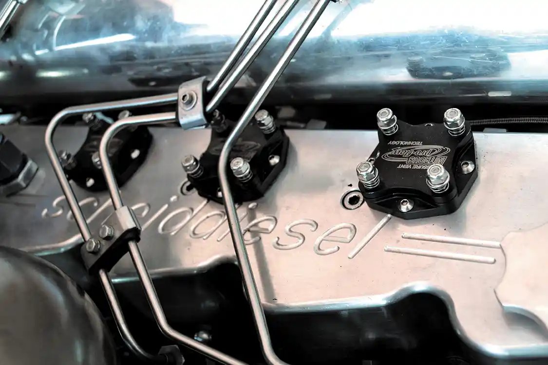 Another safety feature are these cool pop-off valves designed to release pressure in case of a failure that leaks compression into the oiling system. If crankcase pressure exceeds 15 psi, they'll pop up, and keep oil losses to a minimum, as well as ensuring no fluid hits the track surface.