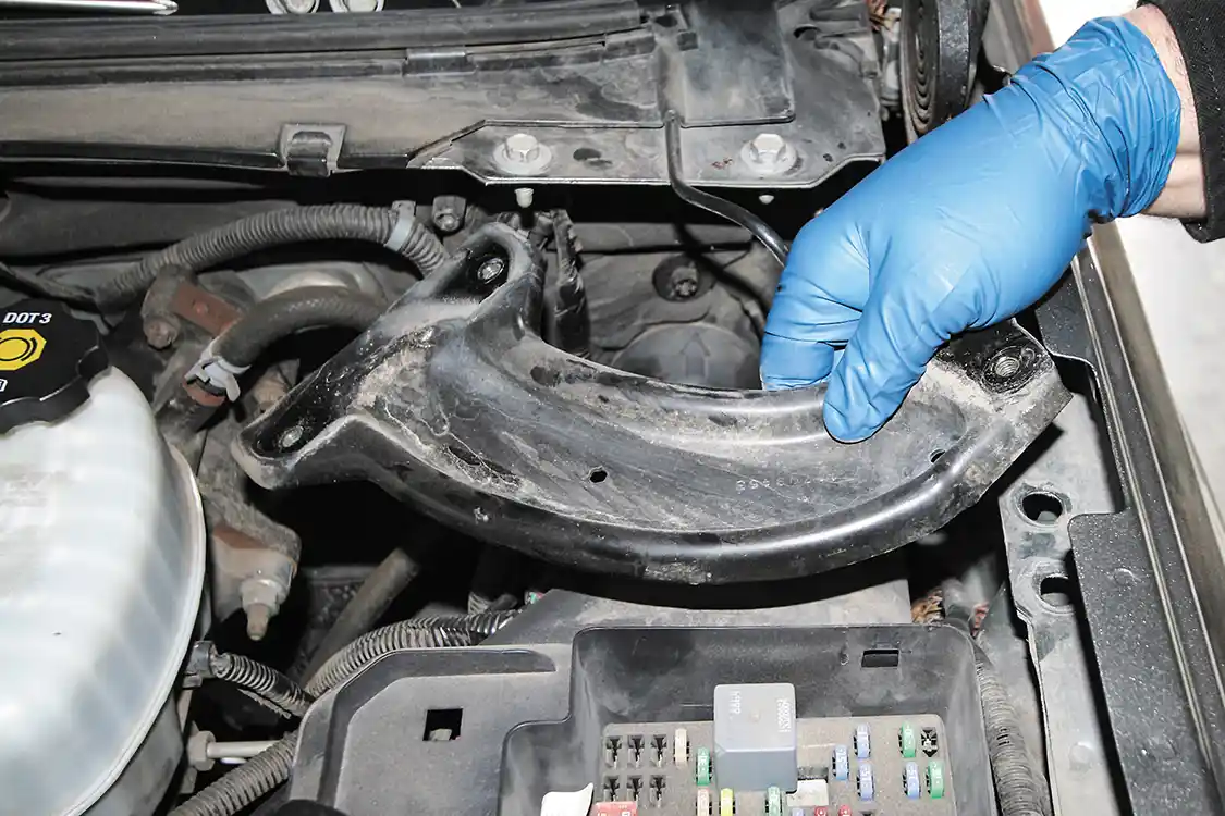 5. We turned to Stanton Performance for the install, and owner Jeremy Stanton had the SpeedBrake installed in a couple of hours. After disconnecting the negatives from the battery terminals, he began the install by removing this support bracket to gain access to the fuse panel.