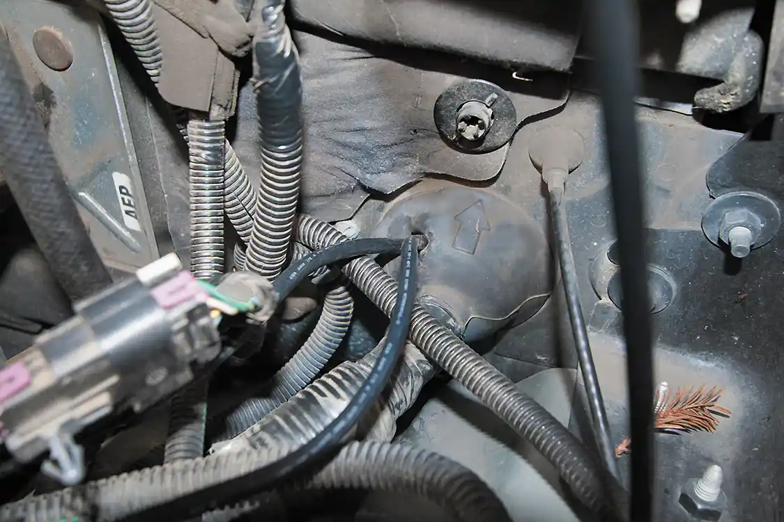 13. We taped the wires to some metal wiring and fed it through a rubber grommet on the firewall.
