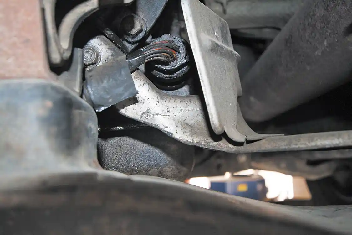 15. Next, move underneath the truck and find the main transmission harness connector on the backside of the transmission; unplug it.