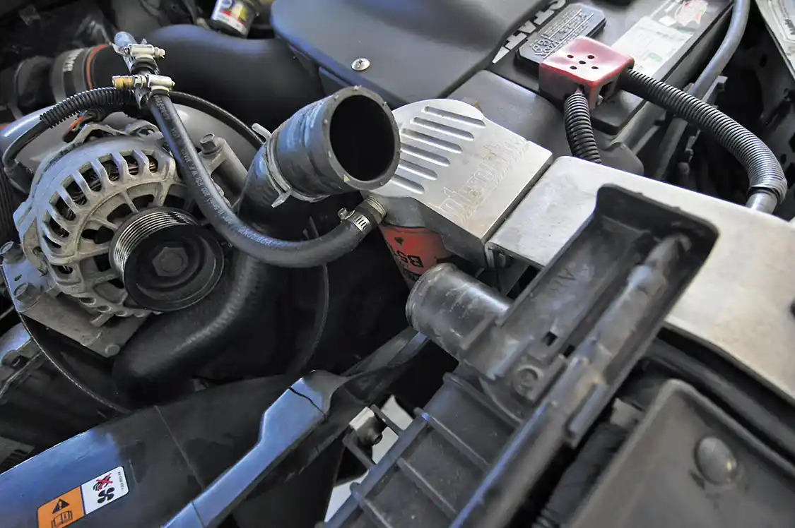 2. Next we drained the radiator and removed the upper radiator hose as well as the Degas bottle, so the fan and shroud could be removed as an assembly.