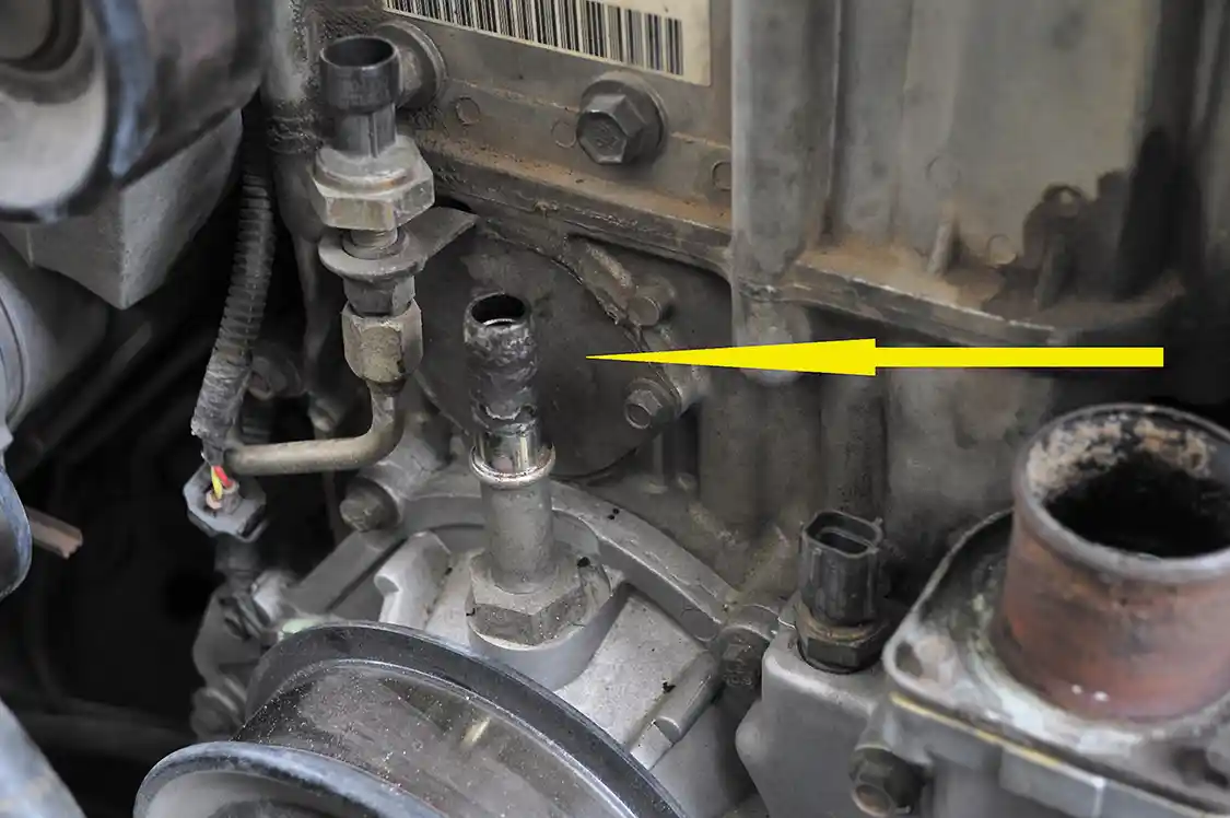 6. All that holds the HPOP on at this point is one bolt located behind this access plate on the front of the engine just above the water pump.
