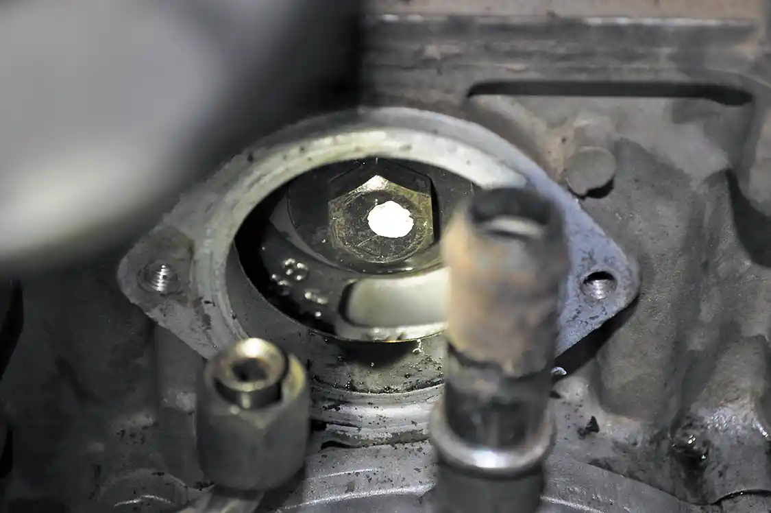 7. When removing this final bolt, we used a small magnet to hold onto the bolts washer to stop it from falling down into the front cover. This bolt is also what secures the gear that runs the HPOP to the HPOP, but the gear is too large to fall into the front cover, so we didn’t have to worry about capturing it.