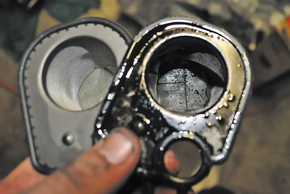 9/10. This is the HPOP oil reservoir (top). Between it and the front cover is a screen filter (here) which stops any large contaminants from entering the HPOP, and later the injectors. DieselSite includes a new filter with the Adrenaline, so of course, we replaced ours.