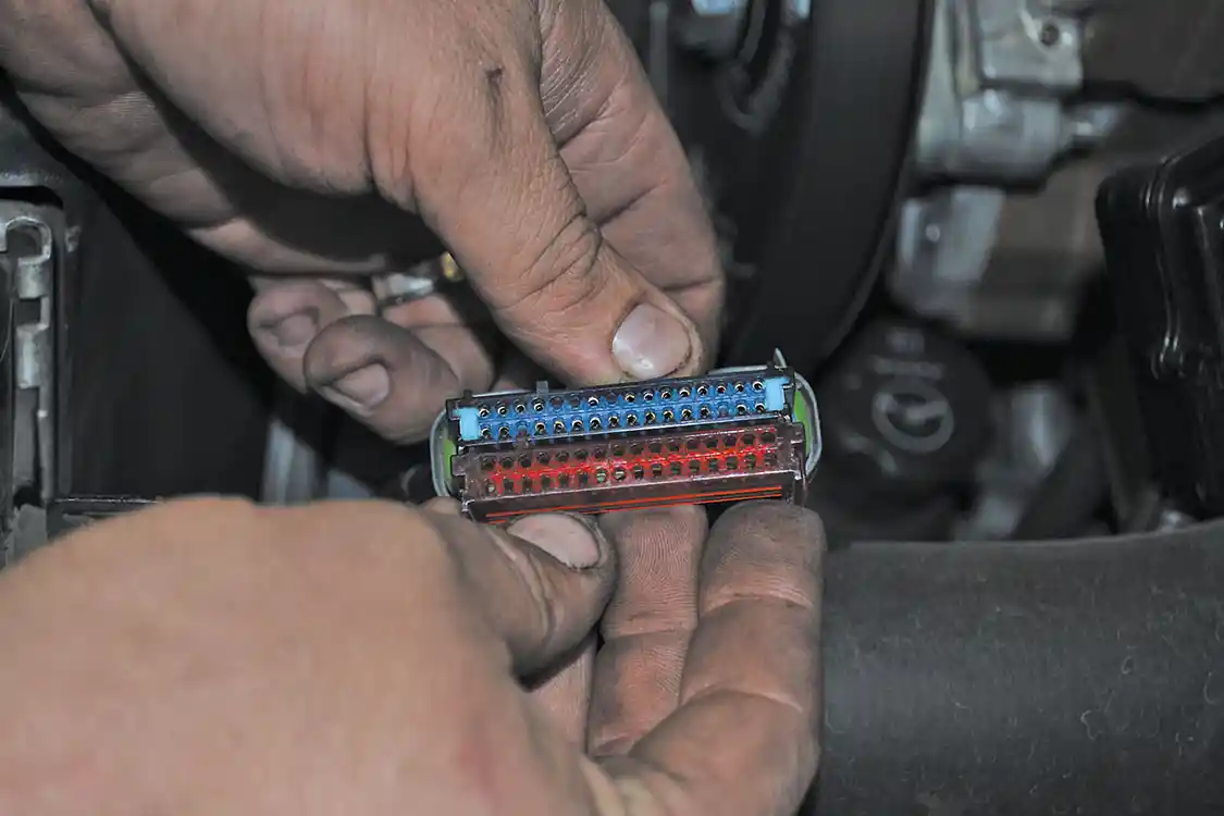 9. The factory red retainer is removed, and a BD-supplied blue retainer is installed to enable the TCM to function with the new and improved shifter.