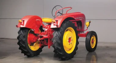 Though a rear three-point hydraulic lift was technically optional, it was so common in the U.S. imports that you could say “every one” had it. This one is missing its lower arms and links but has the adjustable hitch. For the Standard, the lift was a Class II and rated for about 2,800 lbs. The specs say this tractor was rated for a 2-14 mouldboard plow. When you look at specs for the four Porsche-Diesel tractor models, the plow rating is tied directly to the number of engine cylinders, in this case: two bottom for two cylinders. The hoop-like device on the rear fender is the passenger seating area. Not comfortable, but secure.