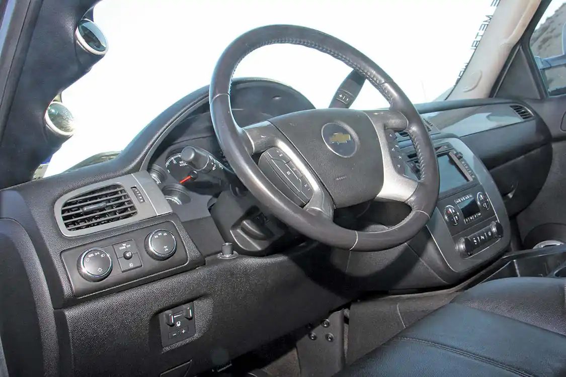 The factory stereo/navigation head unit was retained, but <a href="https://www.wetsounds.com/">Wet Sounds</a> 6-inch speakers in the door and center console boost the tunes quite well. The seats are black leather and the trim pieces have all been color-matched with the exterior.