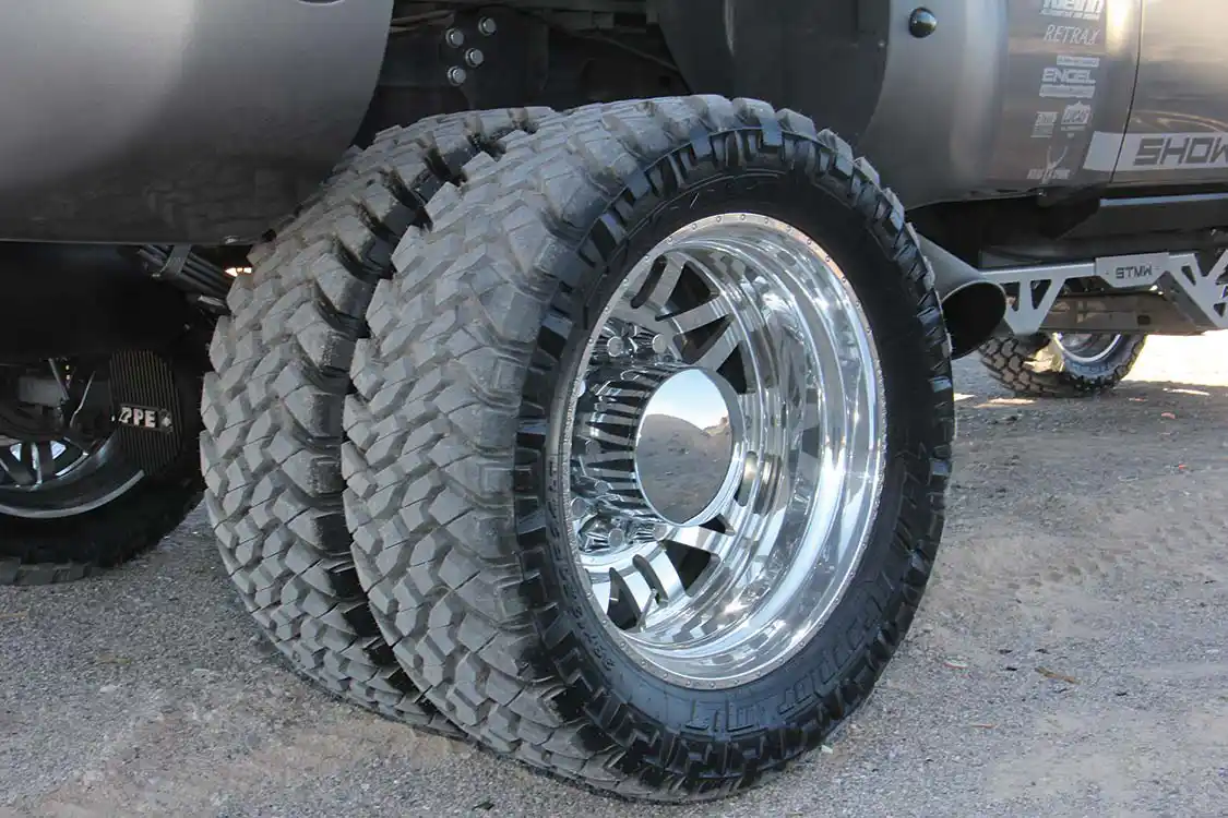 The tires of choice are <a href="https://www.nittotire.com/">Nitto</a> Trail Grapplers, size 38x13.50R24. These are mounted on <a href="https://americanforcewheels.com/">American Force</a> 24-inch Scope wheels. Six wheels are required to roll down the road in style on this dually.