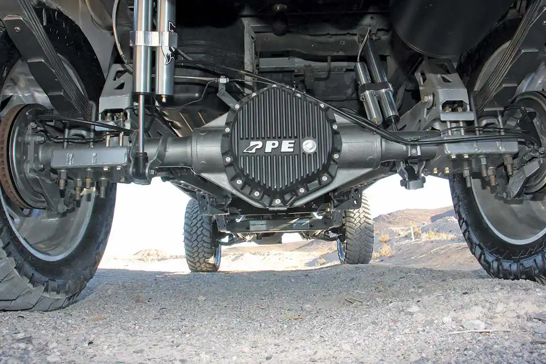 A high-capacity aluminum rear differential cover from PPE has been swapped for the stock cover. This aftermarket beauty adds oil capacity and aids in shedding heat. You can also see the remote-reservoir Fox 2.0 rear shocks and the Rize suspension mountings too.