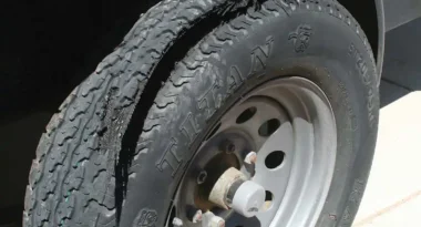 Even though this trailer tire was showing good pressure and a nice deep tread, it failed. Most likely this was due to the fact that the tire date code showed it was over 10 years old, and had deteriorated internally. This tire failure caused additional damage to the trailer fenders that wouldn’t even allow the spare to be run, without some roadside blacksmith work on the bent fender. A simple check of dated codes would have encouraged the owner to replace the aged tires on this trailer. Any tire retailer can do tire date code readings, or you can do it yourself.