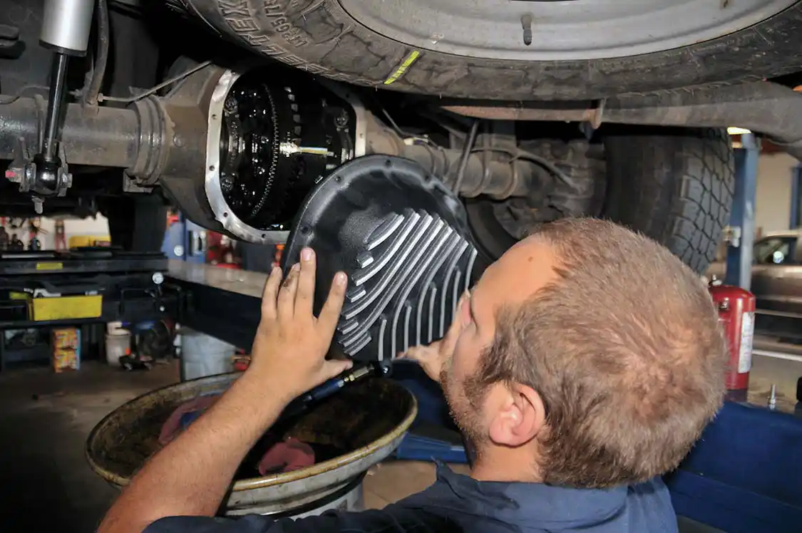 3. Using ACDelco engine sealant (RTV), Cory laid a bead all the way around the gasket flange of the differential pan. A steady hand helps to get the cover lined up without smearing the RTV all over the place. New Allen head bolts, supplied by PML, were then used to secure the new PML pan.
