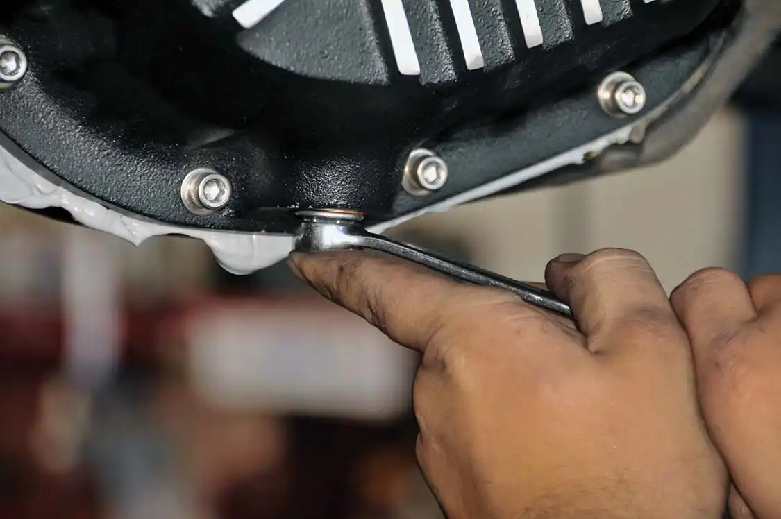 4. PML’s diff cover has a magnetic drain plug with a copper gasket. A little snug “oomph” is all that’s needed to seat the bolt. After giving the excess RTV some time to harden, Cory neatly removed it with a razor blade.