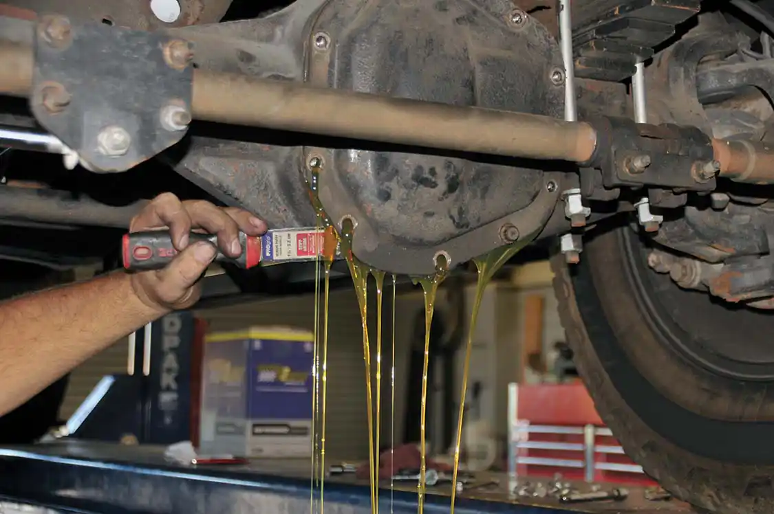 9. On to the front differential. Once all the bolts were out, Cory used a putty scraper to break the seal and let the lube out. Isn’t it crazy that there’s no drain plug? PML solves that issue.