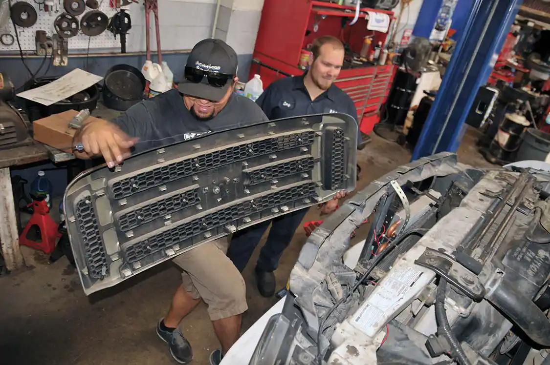 23. Truck owner Juan got back into the action when it was time to put the grille back on.